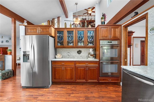 7300 W Stetson Pl Unit 46, Littleton, CO 80123 - kitchen with stainless steel appliances, decorative backsplash, dark wood-type flooring, glass insert cabinets, and brown cabinetry
