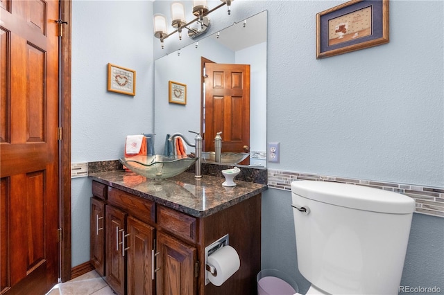 7300 W Stetson Pl Unit 46, Littleton, CO 80123 - bathroom featuring vanity, toilet, tile patterned floors, a wainscoted wall, and tile walls