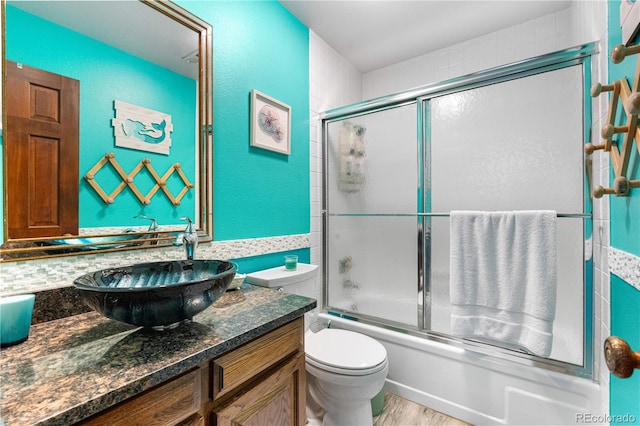 7300 W Stetson Pl Unit 46, Littleton, CO 80123 - bathroom with vanity, toilet, combined bath / shower with glass door, and wood finished floors