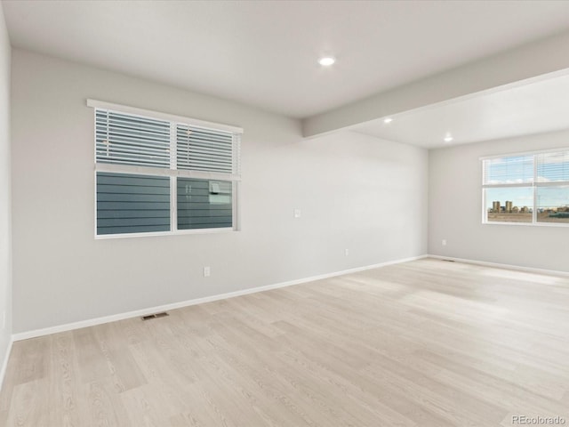 spare room featuring light hardwood / wood-style floors