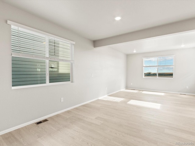 unfurnished room with light wood-type flooring