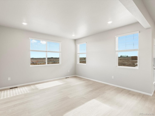 spare room with light hardwood / wood-style floors