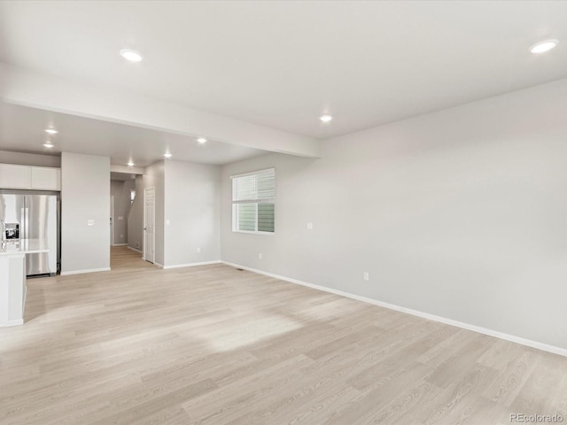 unfurnished living room featuring light wood-type flooring