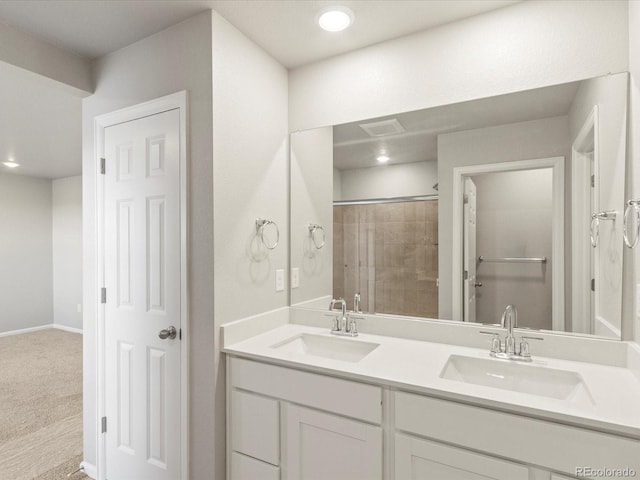 bathroom featuring an enclosed shower and vanity