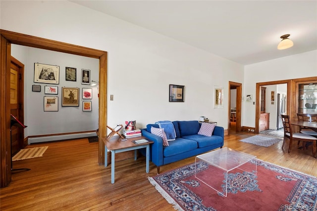 328 S Lincoln St, Denver, CO 80209 - living room with a baseboard radiator, wood finished floors, and baseboards