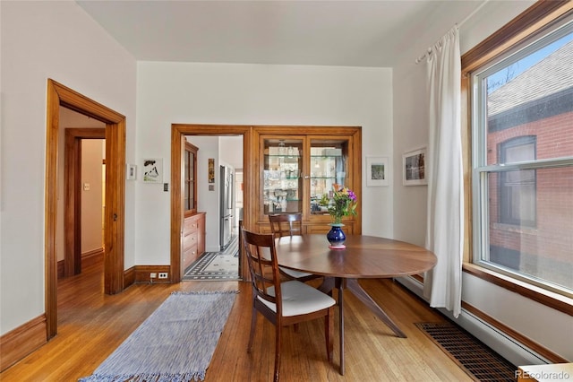 328 S Lincoln St, Denver, CO 80209 - dining space featuring light wood finished floors and baseboards