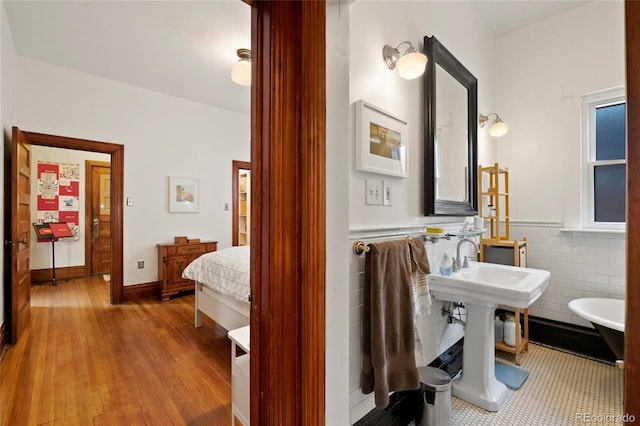 328 S Lincoln St, Denver, CO 80209 - bathroom with a wainscoted wall, wood finished floors, and tile walls