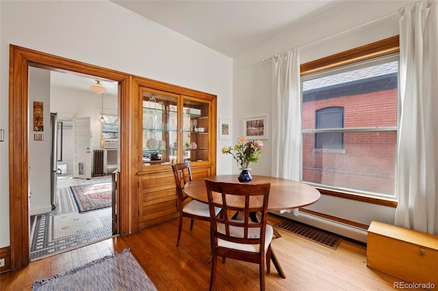 328 S Lincoln St, Denver, CO 80209 - dining space with wood finished floors and baseboard heating