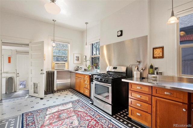328 S Lincoln St, Denver, CO 80209 - kitchen with stainless steel countertops, stainless steel appliances, radiator heating unit, brown cabinetry, and a sink