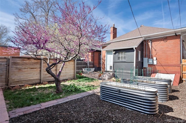 328 S Lincoln St, Denver, CO 80209 - back of property with a fenced backyard, a chimney, and a shingled roof