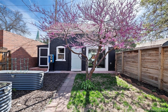 328 S Lincoln St, Denver, CO 80209 - rear view of property with a fenced backyard and brick siding