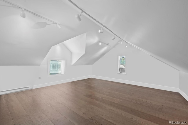 328 S Lincoln St, Denver, CO 80209 - additional living space featuring vaulted ceiling, baseboards, wood finished floors, and healthy amount of natural light