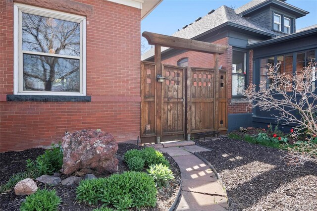 328 S Lincoln St, Denver, CO 80209 - view of exterior entry with a gate and brick siding