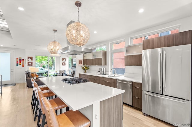3612 Wyandot St, Denver, CO 80211 - kitchen with stainless steel appliances, modern cabinets, a chandelier, a breakfast bar area, and recessed lighting