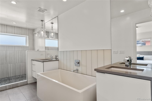 3612 Wyandot St, Denver, CO 80211 - full bath featuring a freestanding bath, tile patterned flooring, two vanities, a walk in shower, and recessed lighting