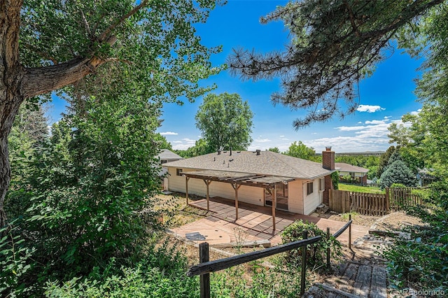 10171 W 69th Ave, Arvada, CO 80004 - back of property with a pergola, a patio, a shingled roof, and a chimney