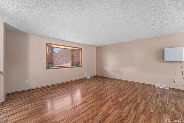10171 W 69th Ave, Arvada, CO 80004 - empty room with wood finished floors and a textured ceiling