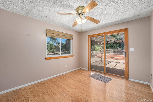 10171 W 69th Ave, Arvada, CO 80004 - empty room with plenty of natural light, light wood-style floors, a textured ceiling, and a ceiling fan