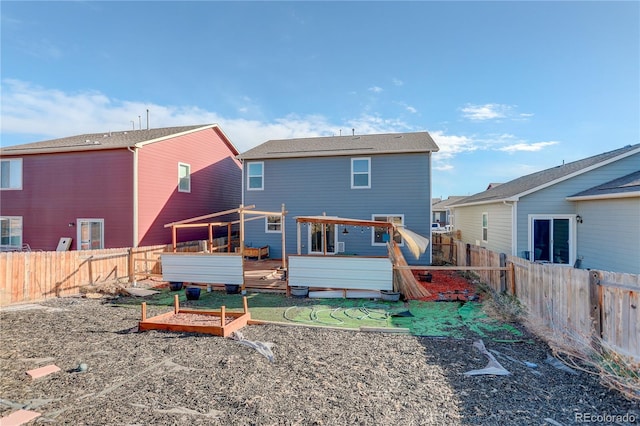 back of property with a wooden deck