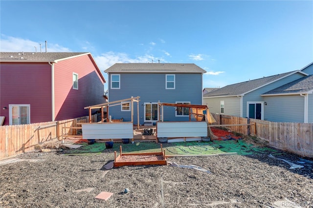 rear view of property featuring a deck