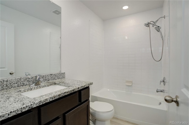 full bathroom featuring vanity, toilet, and tiled shower / bath