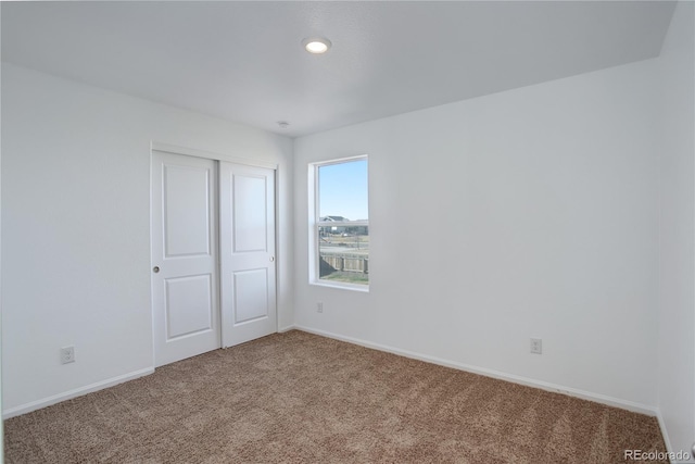 unfurnished bedroom with carpet and a closet