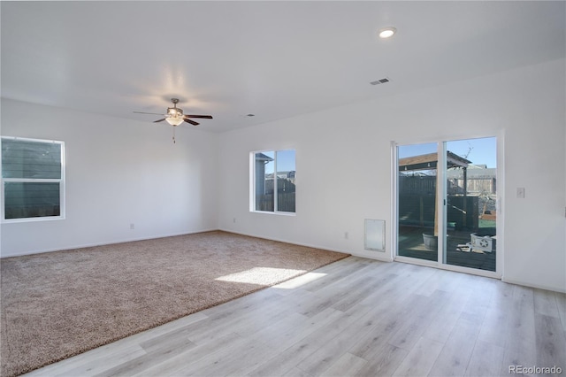 spare room featuring ceiling fan and light hardwood / wood-style floors