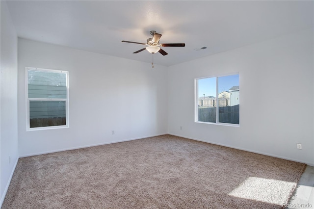 carpeted empty room featuring ceiling fan