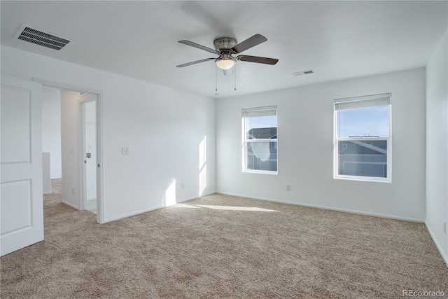 carpeted spare room with ceiling fan