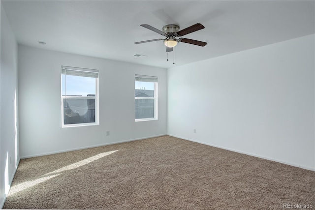 empty room featuring carpet flooring and ceiling fan