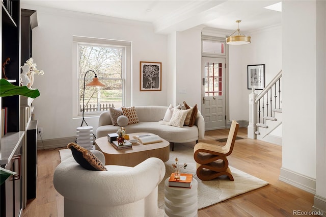 3142 W 26th Ave, Denver, CO 80211 - living room featuring light wood finished floors, baseboards, crown molding, and stairway