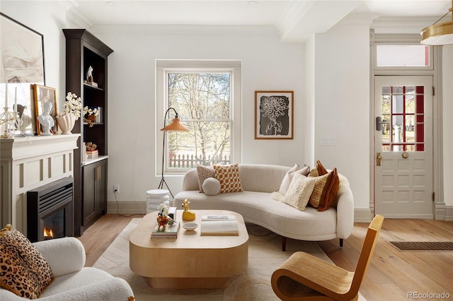 3142 W 26th Ave, Denver, CO 80211 - living area with light wood-style floors, a glass covered fireplace, baseboards, and ornamental molding