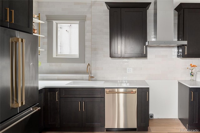 3142 W 26th Ave, Denver, CO 80211 - kitchen featuring stainless steel appliances, wall chimney exhaust hood, a sink, backsplash, and light countertops