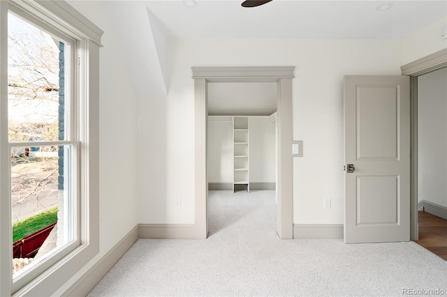 3142 W 26th Ave, Denver, CO 80211 - unfurnished bedroom with multiple windows, carpet, and a walk in closet