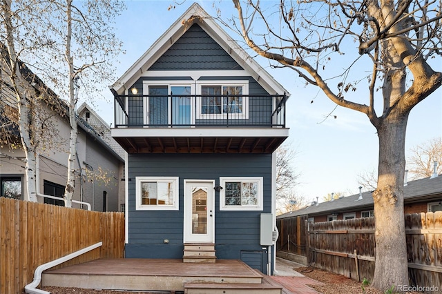 3142 W 26th Ave, Denver, CO 80211 - view of front of home with a balcony, a fenced backyard, a wooden deck, and entry steps