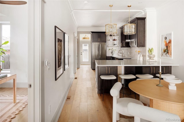 3142 W 26th Ave, Denver, CO 80211 - kitchen featuring stainless steel built in refrigerator, dark brown cabinets, light countertops, a peninsula, and a kitchen bar