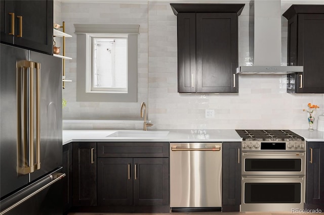 3142 W 26th Ave, Denver, CO 80211 - kitchen featuring premium appliances, wall chimney exhaust hood, a sink, tasteful backsplash, and light countertops