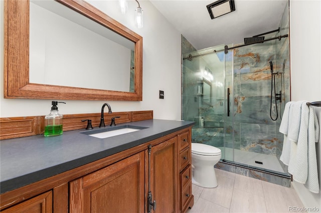 bathroom with walk in shower, tile patterned floors, vanity, and toilet