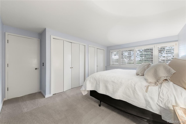 carpeted bedroom featuring two closets