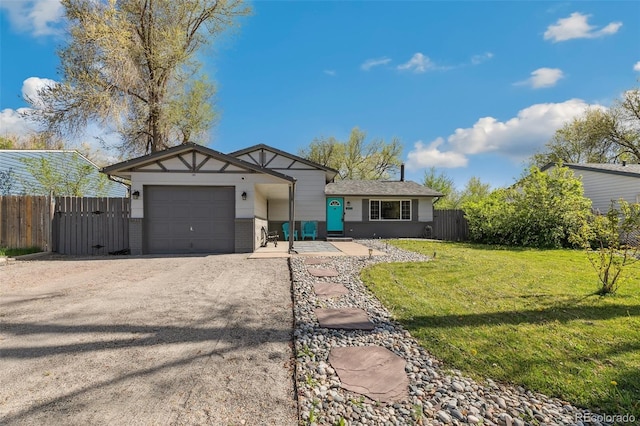 4475 London Ln, Colorado Springs, CO 80916 - view of front of house featuring a garage, fence, a front yard, a gate, and driveway