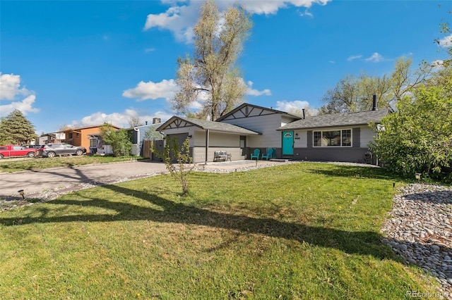 4475 London Ln, Colorado Springs, CO 80916 - tri-level home with a front lawn and driveway