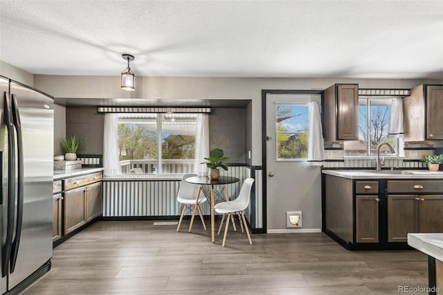 4475 London Ln, Colorado Springs, CO 80916 - kitchen featuring freestanding refrigerator, a sink, wood finished floors, and a healthy amount of sunlight