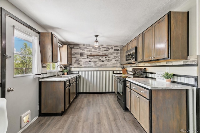 4475 London Ln, Colorado Springs, CO 80916 - kitchen featuring light countertops, stainless steel microwave, black electric range, and a sink
