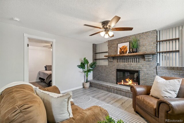 4475 London Ln, Colorado Springs, CO 80916 - living room featuring ceiling fan, a brick fireplace, and a textured ceiling