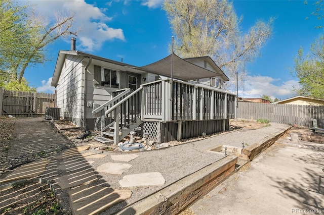 4475 London Ln, Colorado Springs, CO 80916 - view of home's exterior with a fenced backyard, central air condition unit, stairs, and a deck