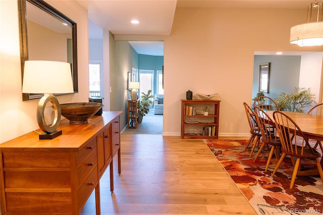 hallway featuring recessed lighting, baseboards, and wood finished floors