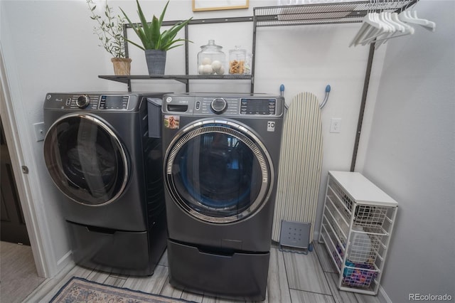 clothes washing area featuring laundry area and washing machine and dryer