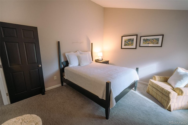 carpeted bedroom featuring vaulted ceiling and baseboards