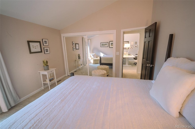 carpeted bedroom with lofted ceiling, baseboards, and a closet