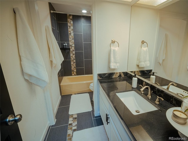 full bath featuring bathing tub / shower combination, vanity, and toilet